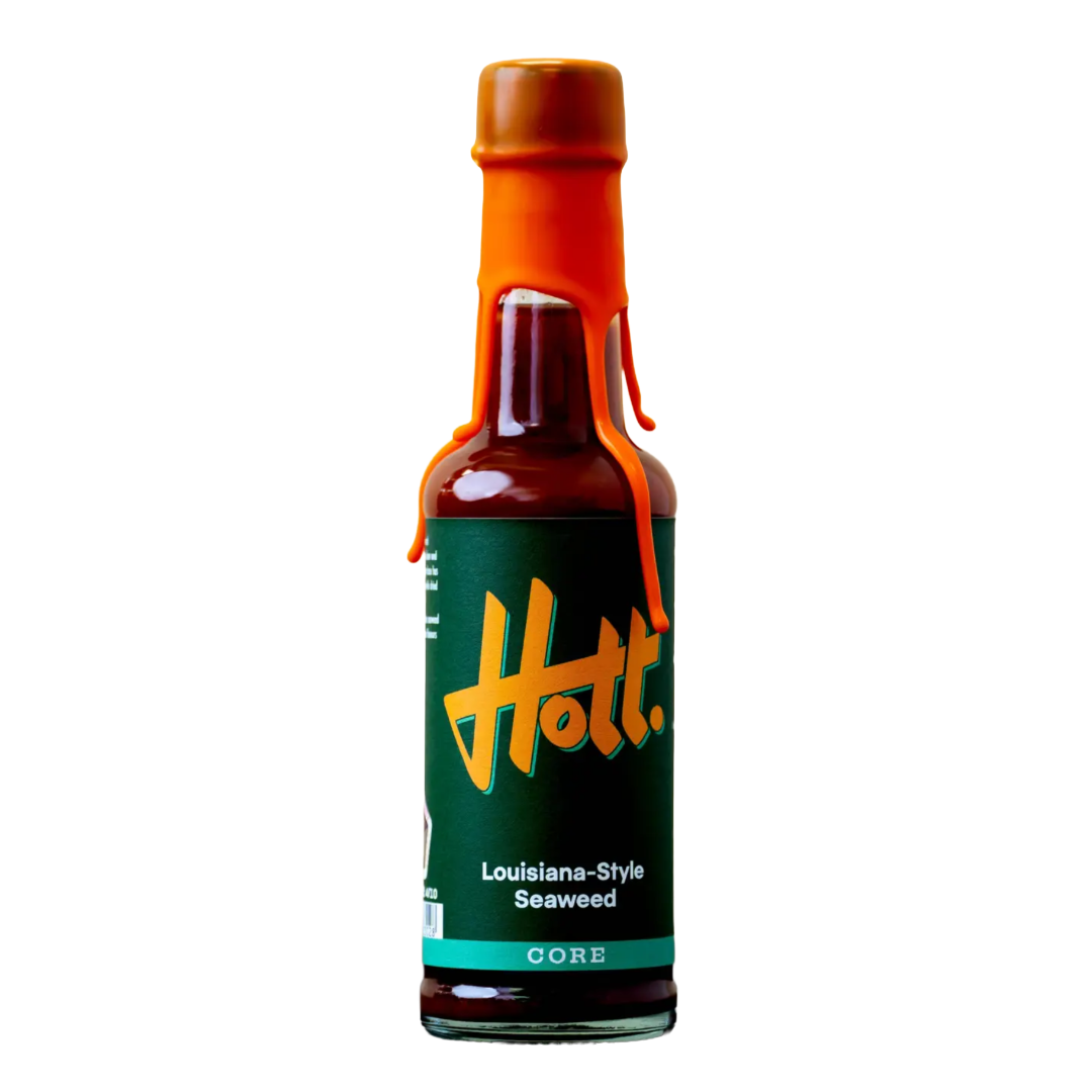 A bottle of Hott. Louisiana-Style Seaweed sauce on a solid white background, featuring a dark green label with a stylized yellow-orange Hott.