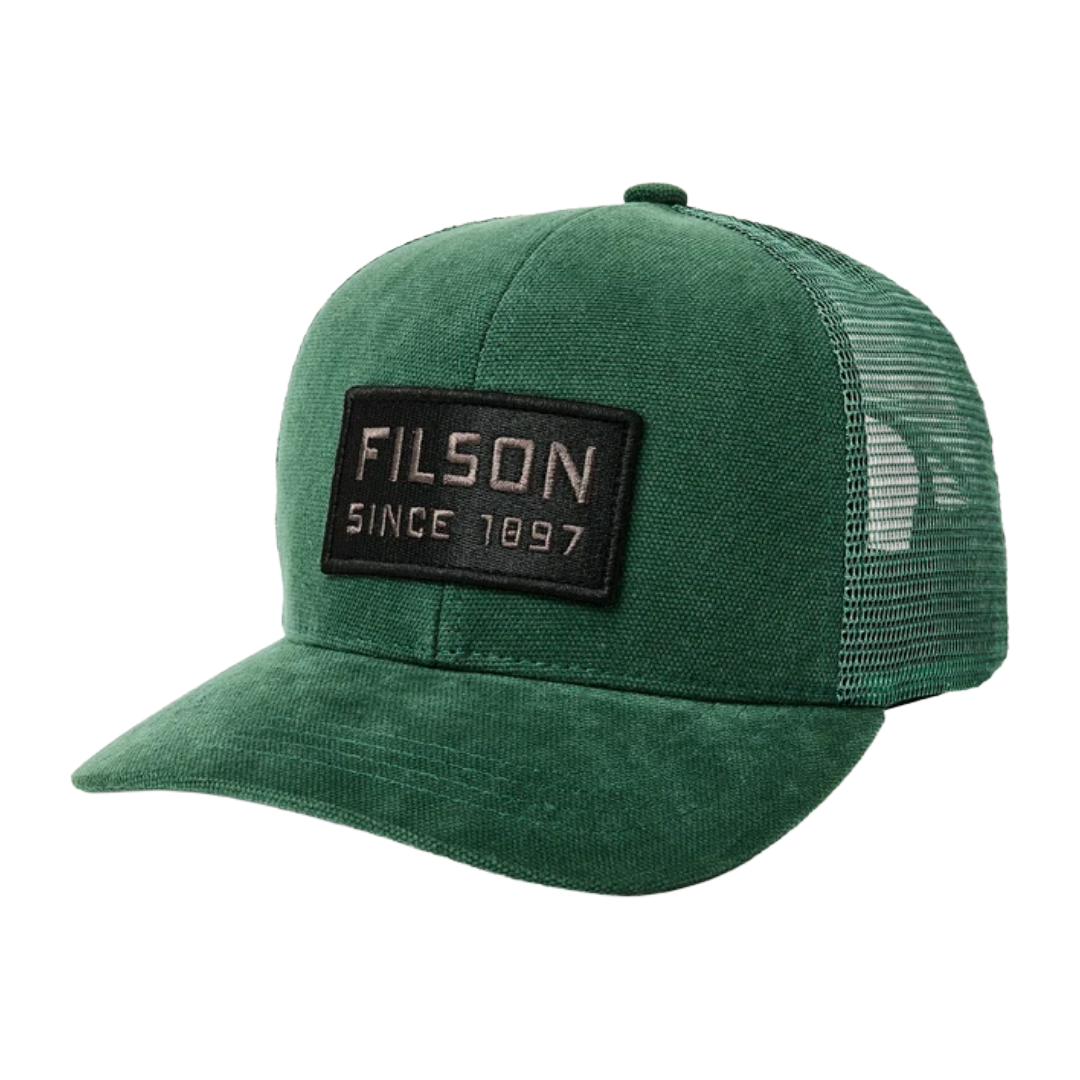 A green trucker hat with a black rectangular patch on the front that reads 'FILSON SINCE 1897' in white text, shown on a plain white background.