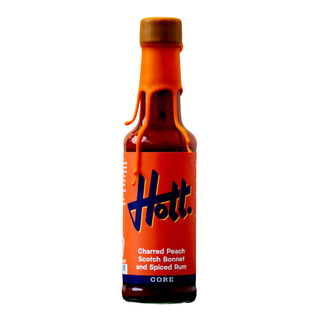 A bottle of Hott. Charred Peach Scotch Bonnet and Spiced Rum CORE on a solid white background.