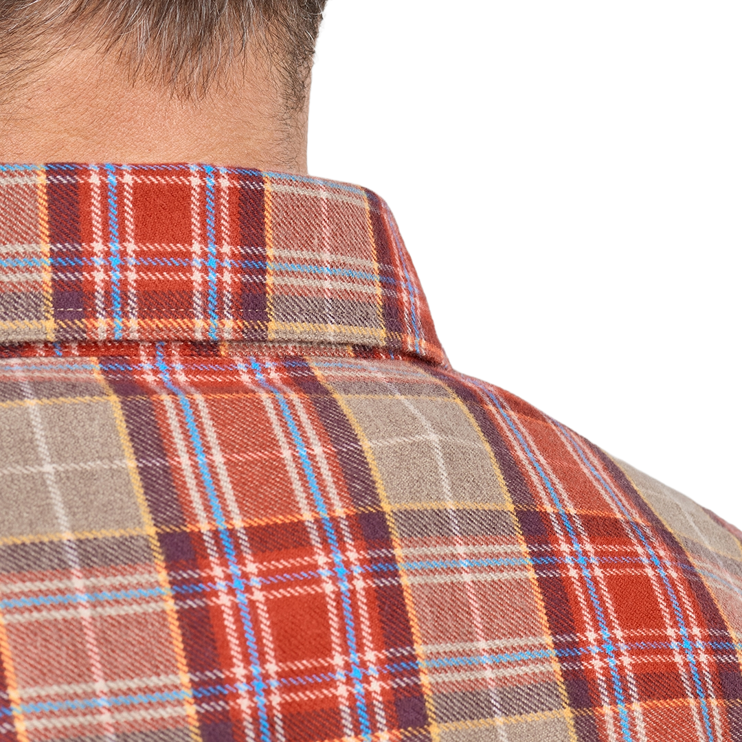 Close-up of a man wearing a collared plaid flannel shirt in rust red, beige, navy, and light blue, with his neck and upper back visible against a plain white background.