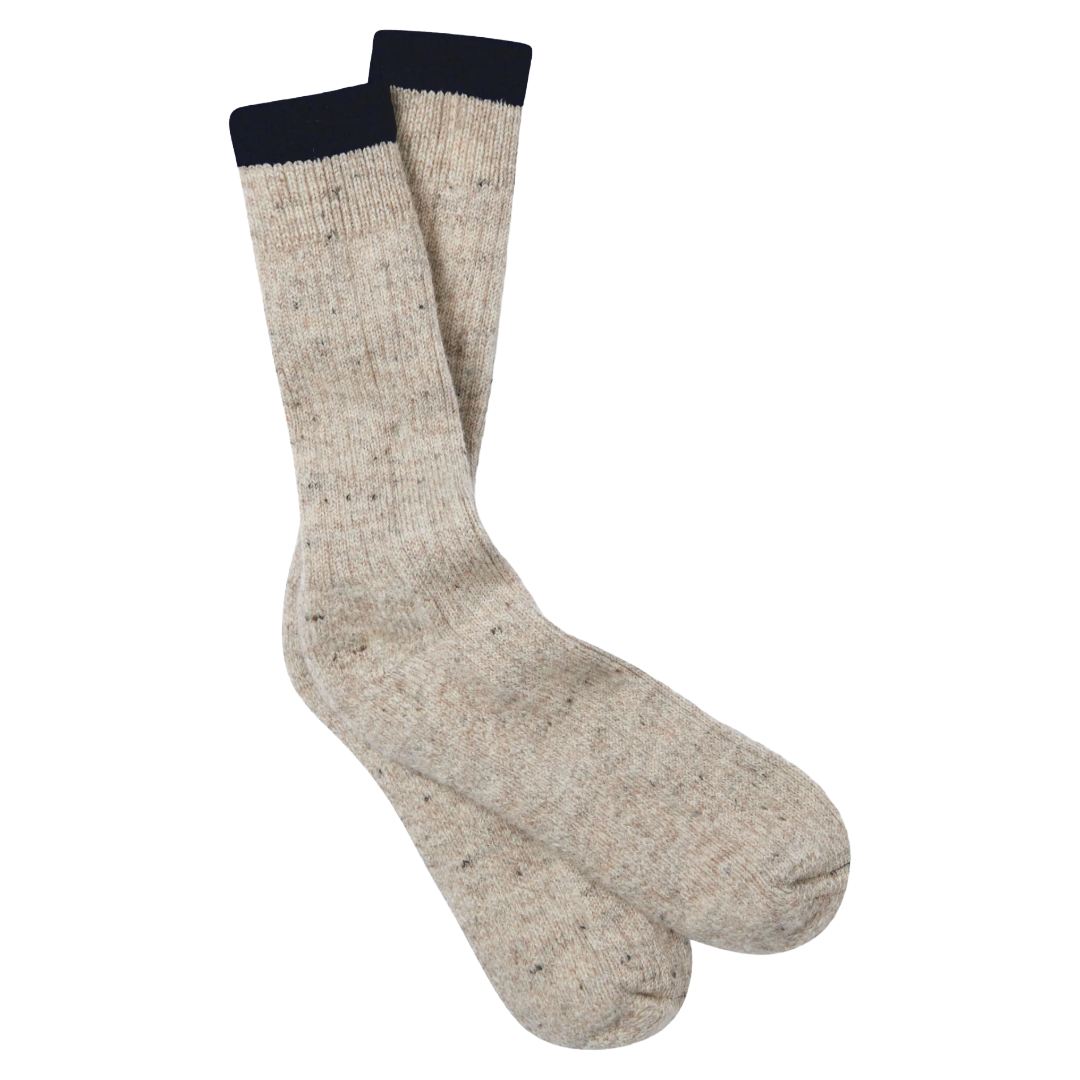 A pair of heathered beige crew socks with a dark navy ribbed cuff, displayed against a solid white background.
