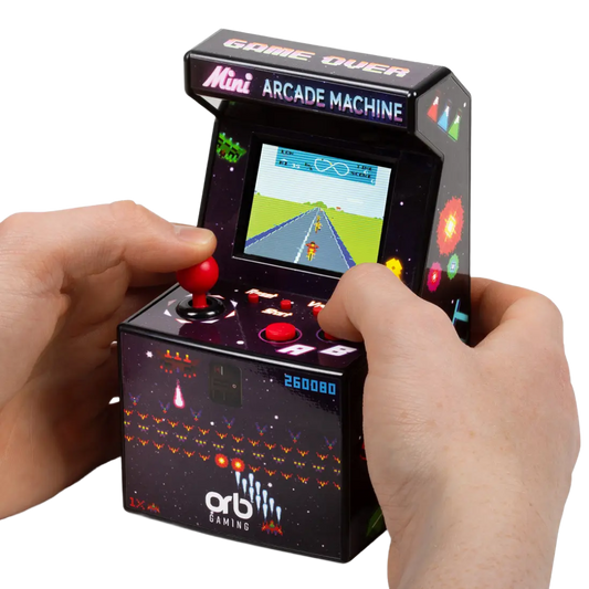 A miniature black arcade machine handheld controller with a red joystick and red buttons, shown being held by two hands against a white background. The front features the 'orb gaming' logo and a retro pixel-art screen showing a green road scene.