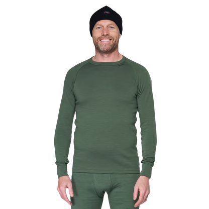 A man wearing a dark green long-sleeve thermal underwear top and matching green pants, along with a black knit beanie, photographed against a plain white background.