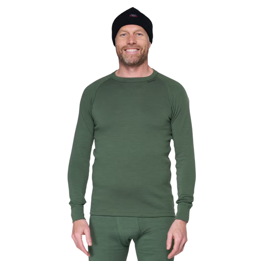 A man wearing a dark green long-sleeve thermal underwear top and matching green pants, along with a black knit beanie, photographed against a plain white background.