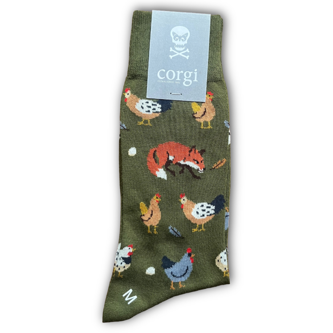 Green sock with animal pattern and 'corgi' brand label on a white background. Sold by regent in Salisbury and made in wales 