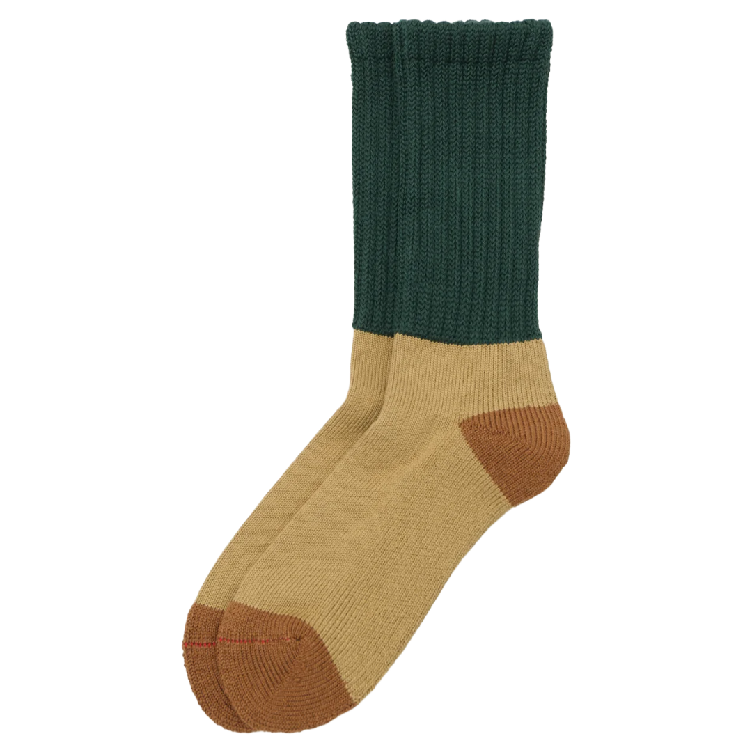 A pair of crew socks with a dark green ribbed cuff, tan body, and brown toe and heel sections, shown on a plain white background.
