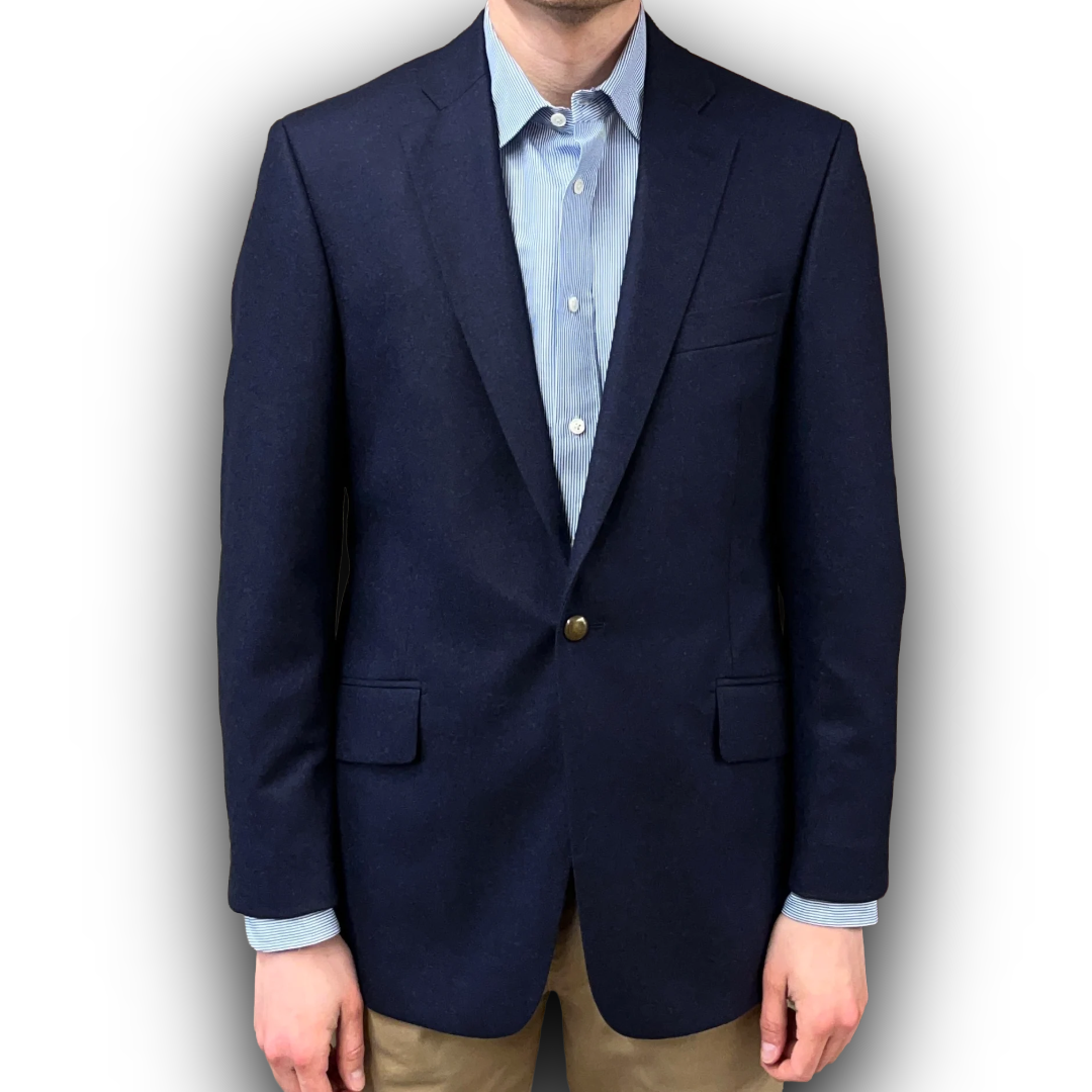 Navy blazer over a light blue shirt with a white background