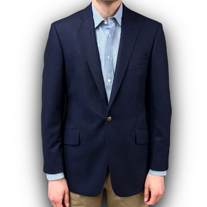 Navy blazer over a light blue shirt with a white background