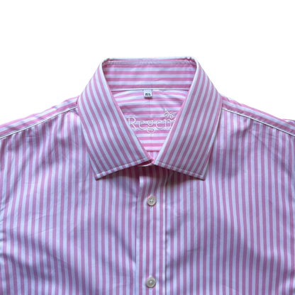 A close-up of a pink and white striped dress shirt with a pointed collar and light-colored buttons, photographed against a plain white background.