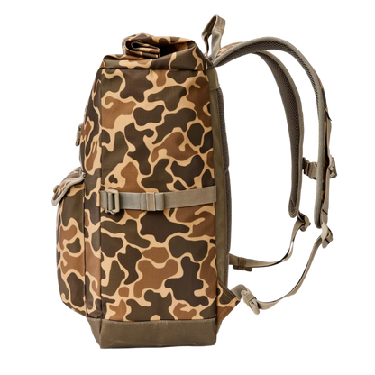 A tactical backpack with a brown, tan, and dark green camouflage pattern, featuring a top roll-top closure, a front utility pocket with a buckle strap, and padded shoulder straps, shown against a plain white background.