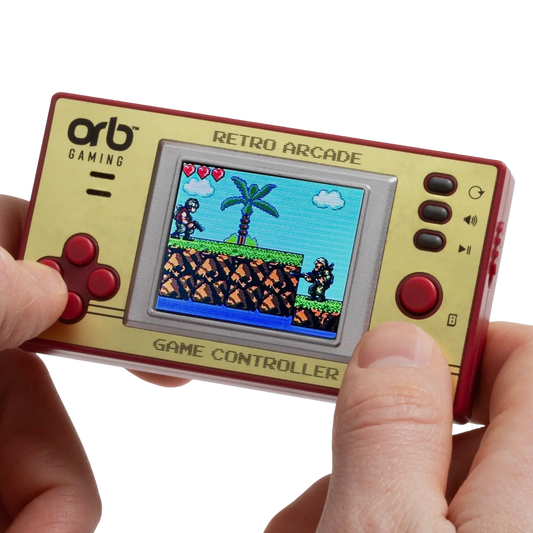 A handheld retro arcade game controller with a gold faceplate, red sides, and red buttons, held by two hands against a white background. The screen displays pixel art of a classic video game scene.