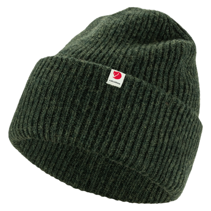 A dark green ribbed knit beanie hat with a small white square brand tag on the front cuff.