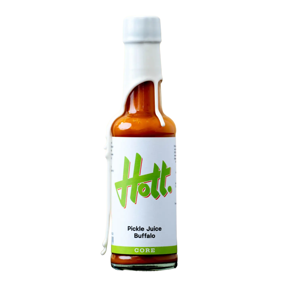 A bottle of Hott. Pickle Juice Buffalo hot sauce with a white label featuring green logo text, set against a plain white background.