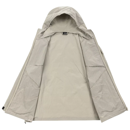 A light beige hooded jacket laid flat against a solid white background, showing its front zipper closure and textured fabric.