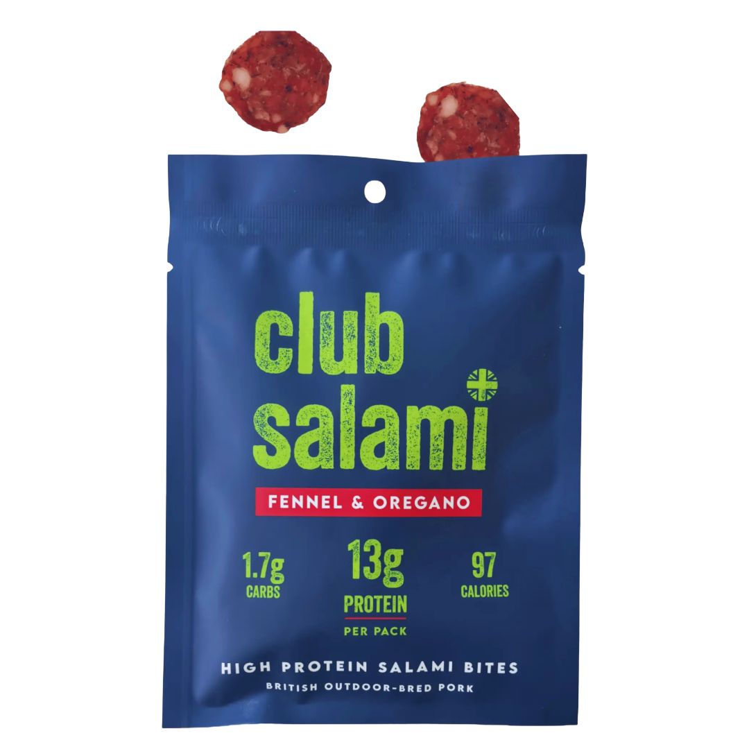 A blue stand-up pouch of Club Salami Fennel & Oregano protein salami bites, with two round salami slices floating above the package on a white background.