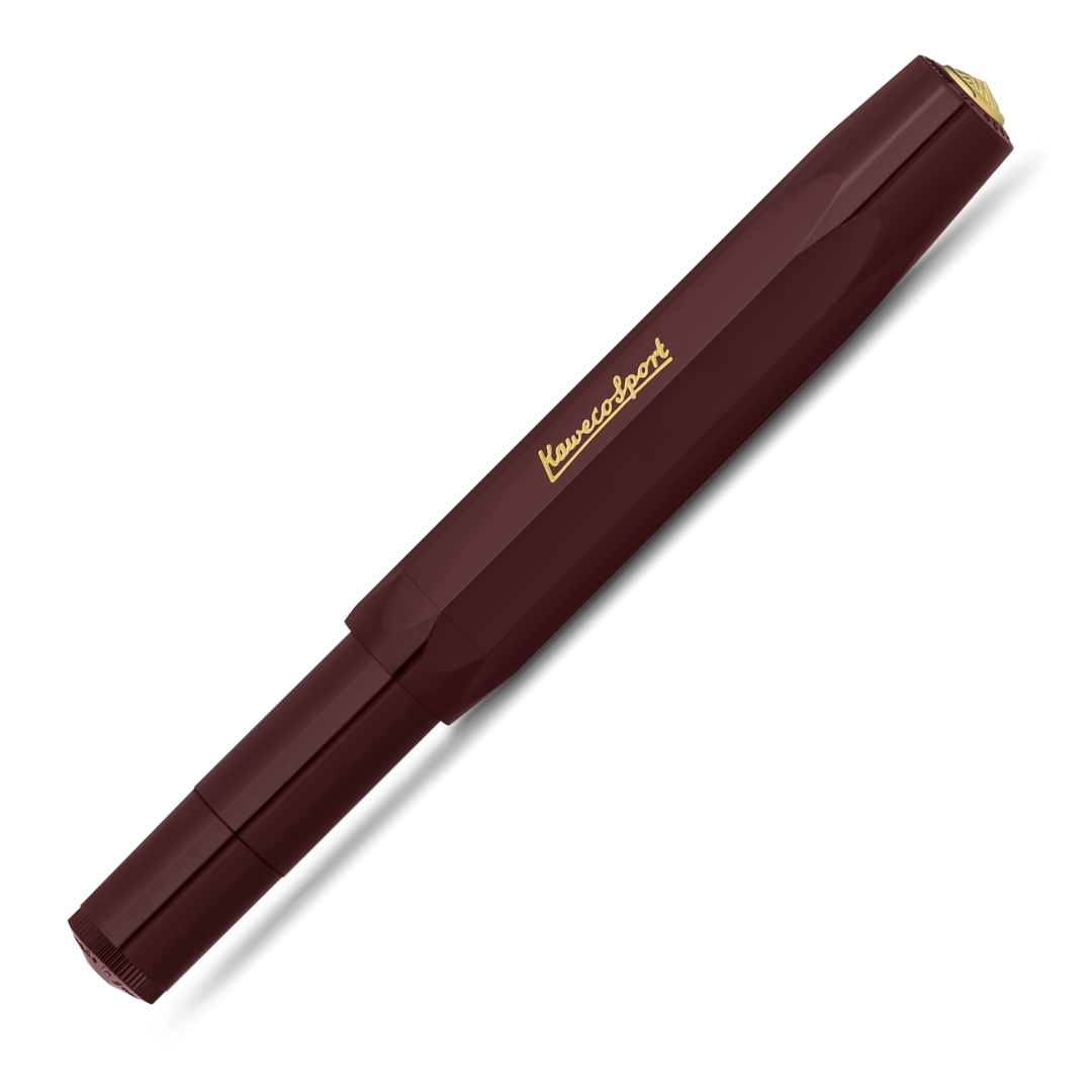 A Kuvings Sport fountain pen in a deep burgundy color with gold lettering and a gold tip, shown diagonally on a white background.