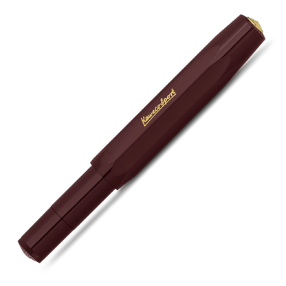 A Kuvings Sport fountain pen in a deep burgundy color with gold lettering and a gold tip, shown diagonally on a white background.