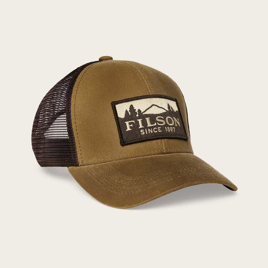 Brown trucker cap with black mesh and Filson logo on a beige background