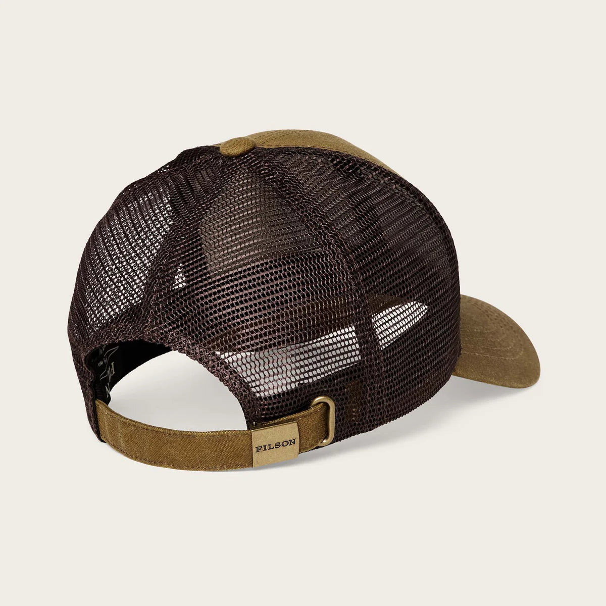 Brown and beige mesh cap with leather brim on a light beige background