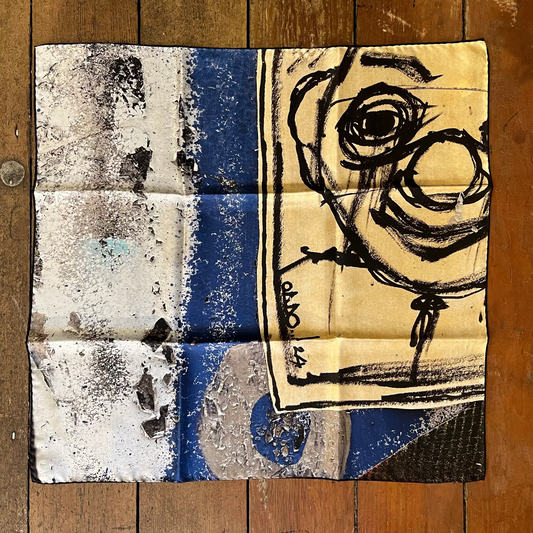 Abstract artwork on a wooden surface with a face-like design and geometric patterns.