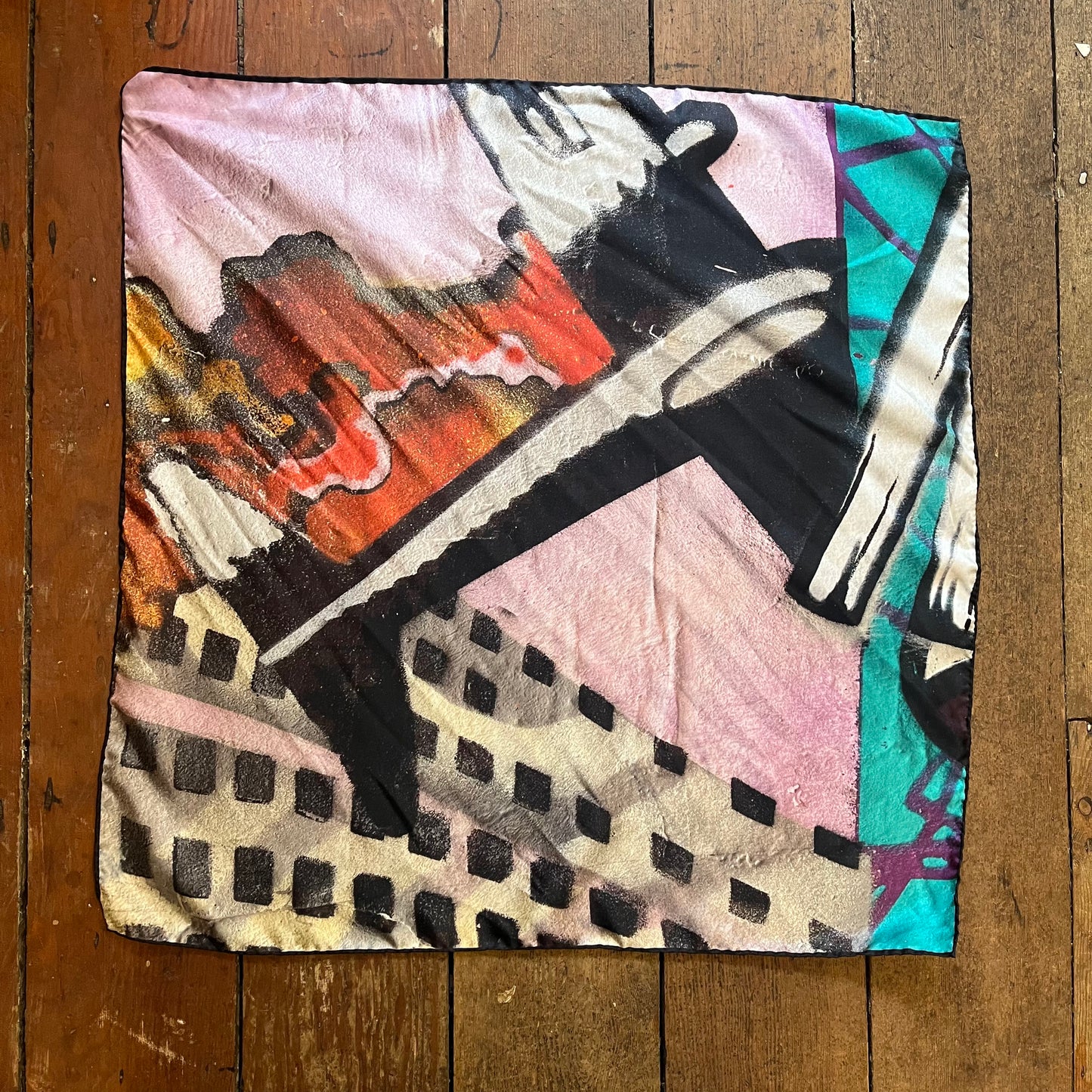 Colorful abstract fabric pattern on a silk neck scarf. plane featured as vocal point.