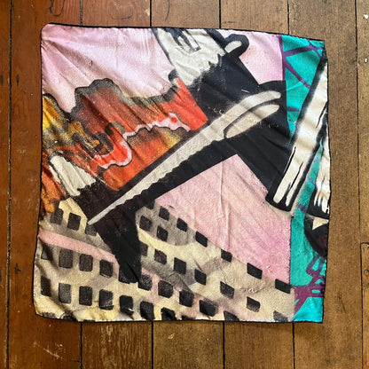 Colorful abstract fabric pattern on a silk neck scarf. plane featured as vocal point.