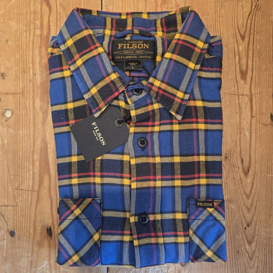 Plaid shirt folded on a wooden table 