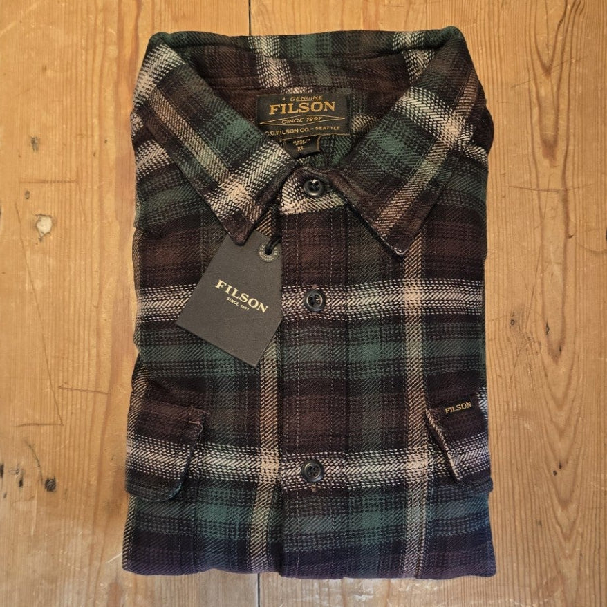 Workwear plaid shirt on wooden surface