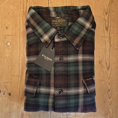Workwear plaid shirt on wooden surface