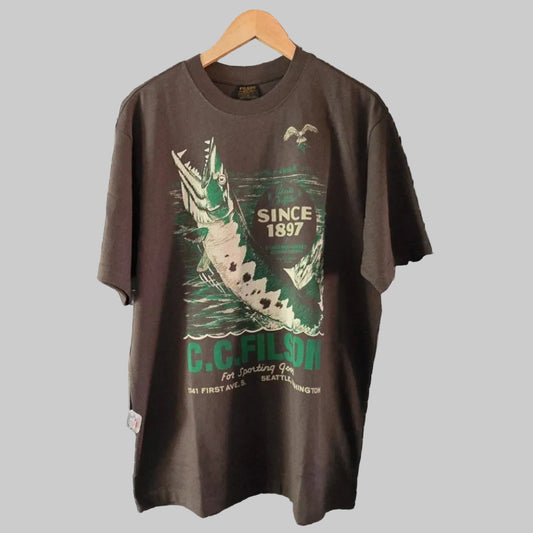 Charcoal t-shirt with graphic design on a hanger against a grid wall