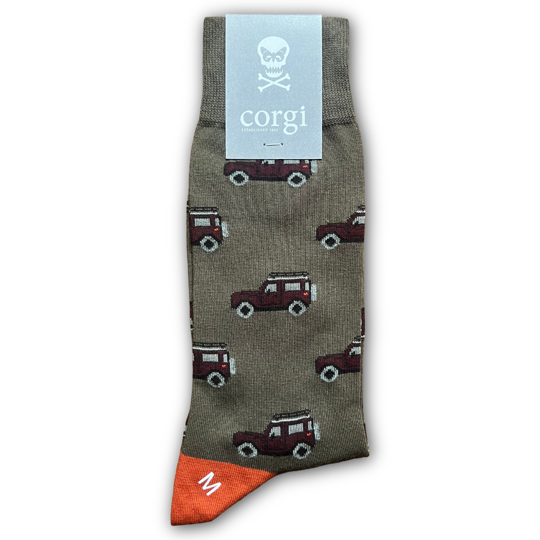 Green Sock with Land Rover  pattern and 'corgi' brand label on a white background. Sold in Salisbury by regent tailoring