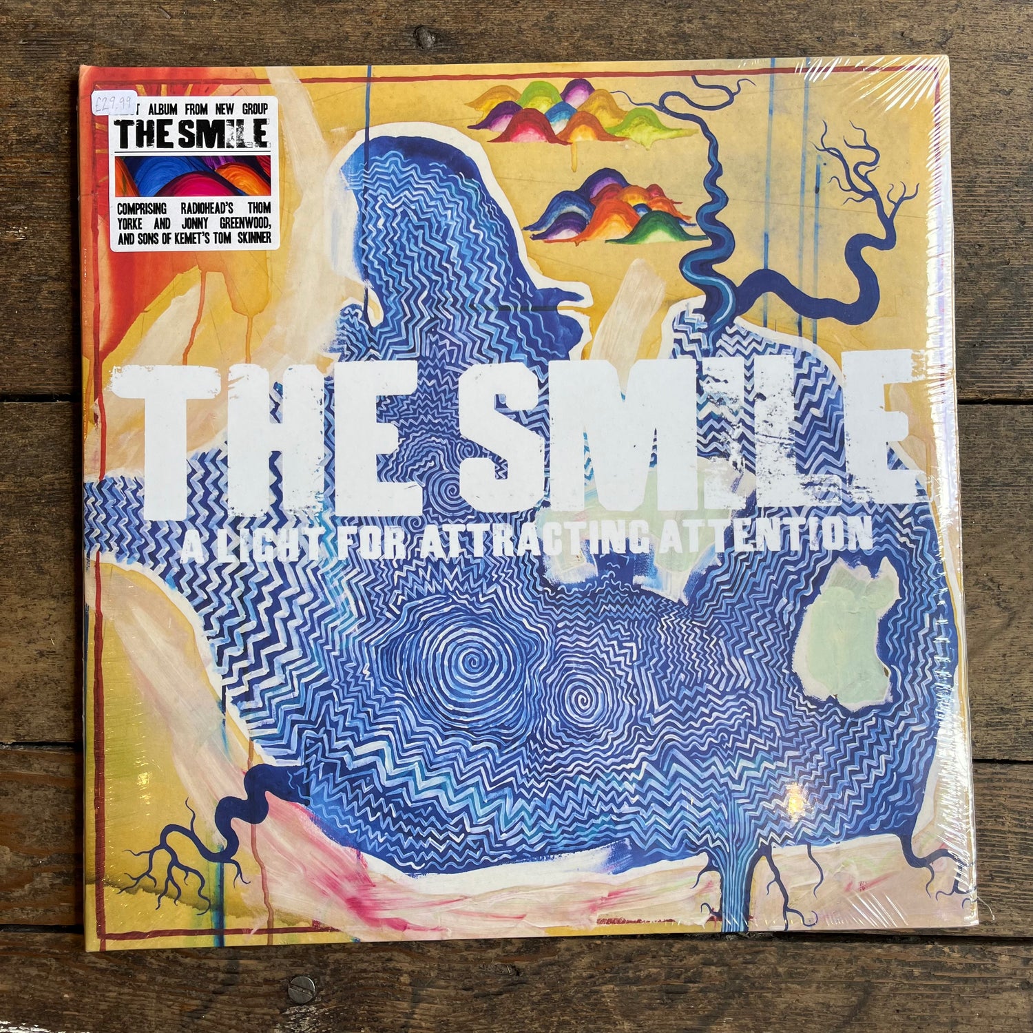 The Smile album on wooden background 
