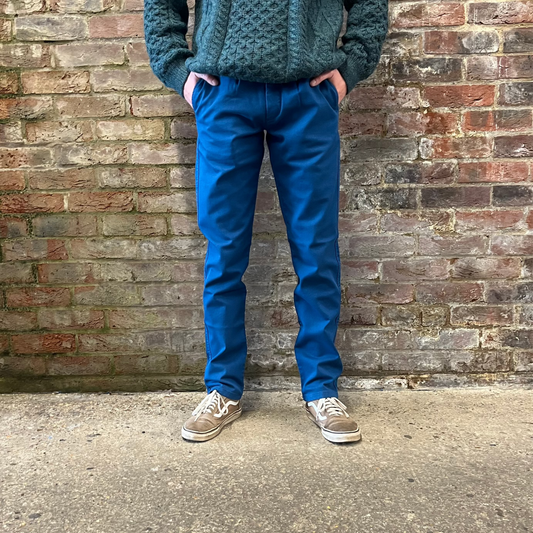 A person wearing blue chinos