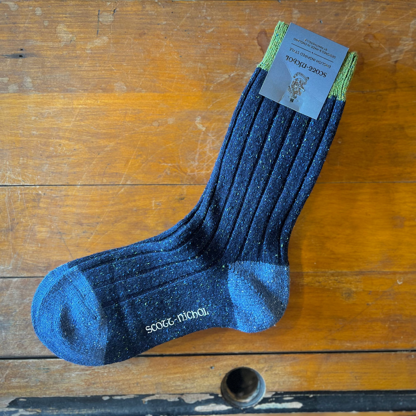 Navy scott-nichol socks on a wooden background