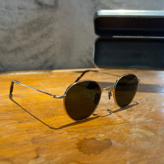 Sunglasses on a wooden desk