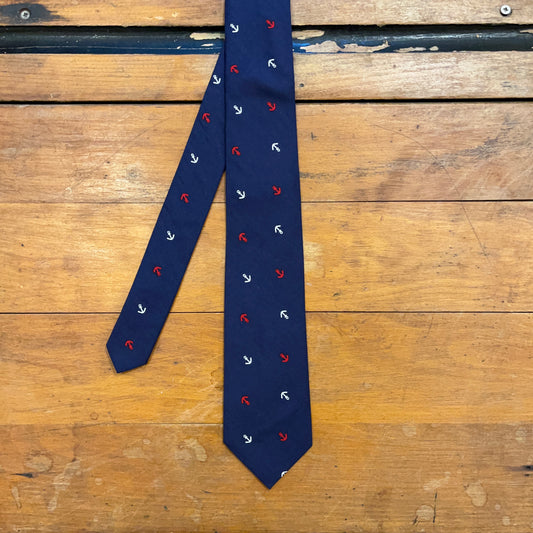 navy cotton tie with anchor pattern on wooden boards