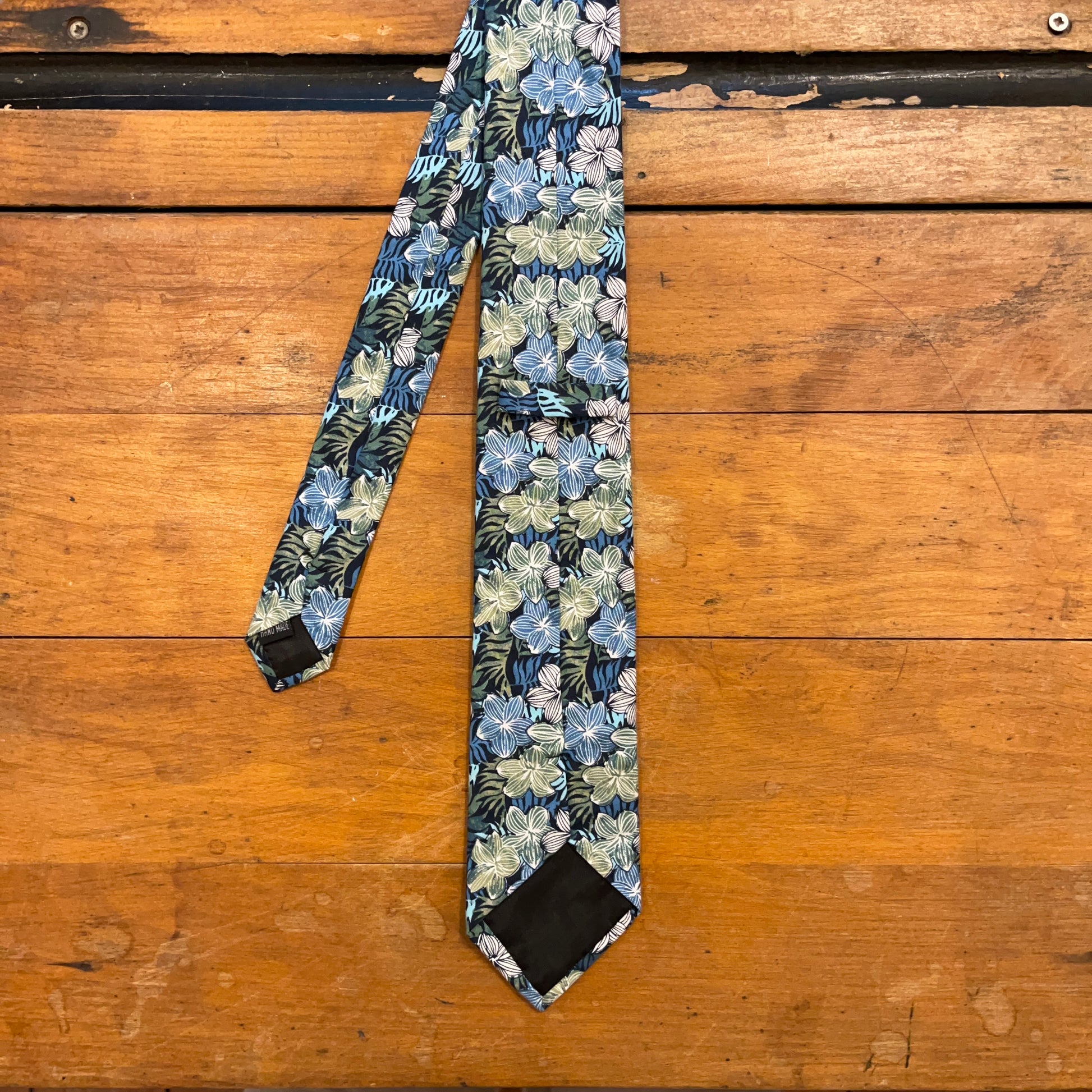 reverse of floral cotton tie on boards