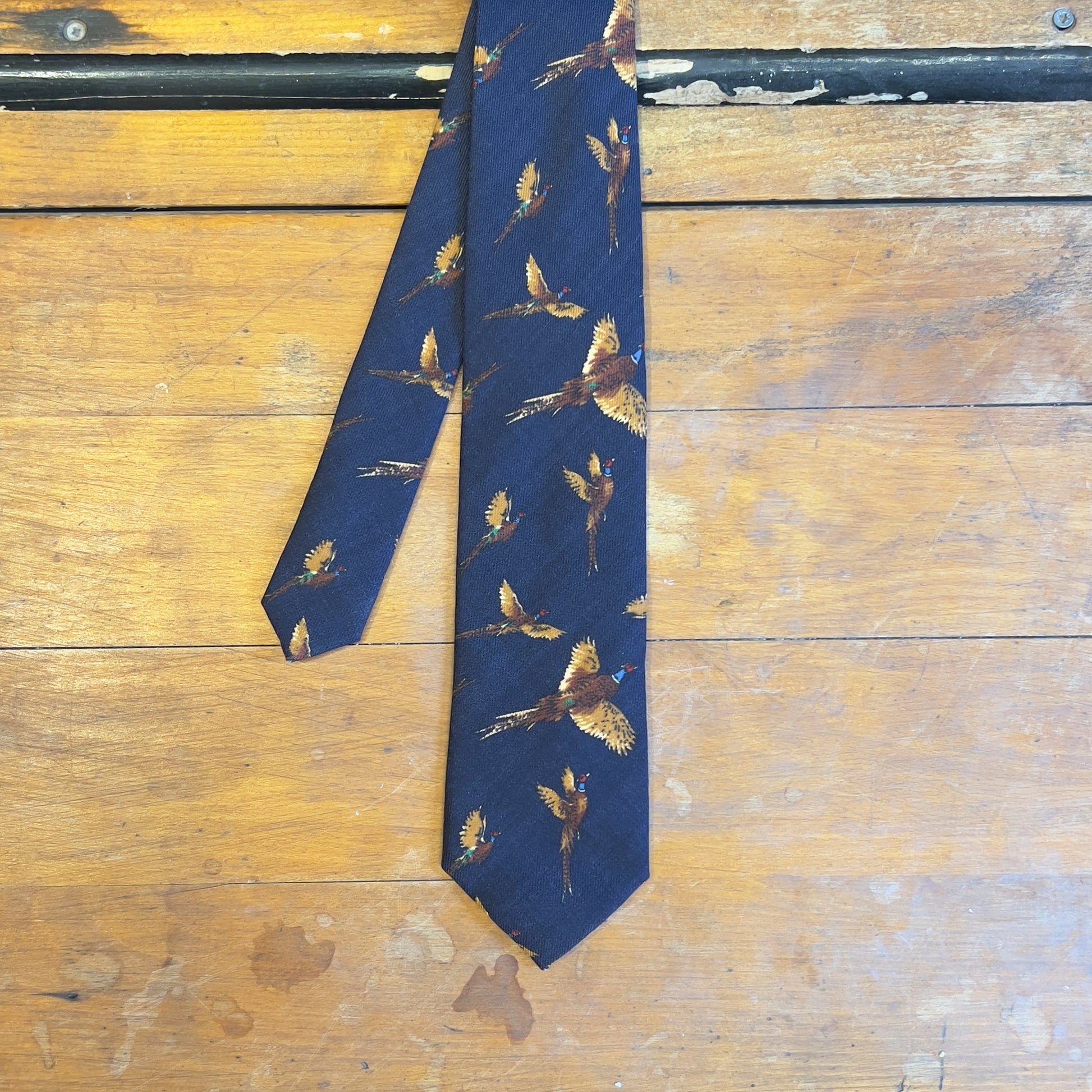 A navy tie with phesants