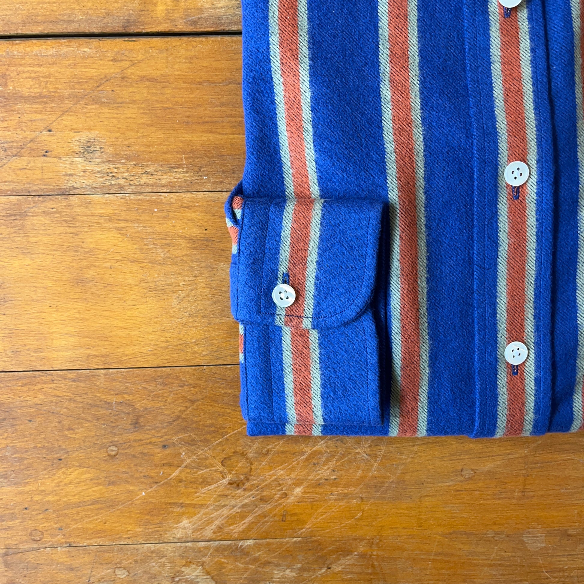 SIngle button cuff of Regent 'Pendleton' Shirt  in blue with orange stripe made from brushed cotton - fastened with mother of pearl button