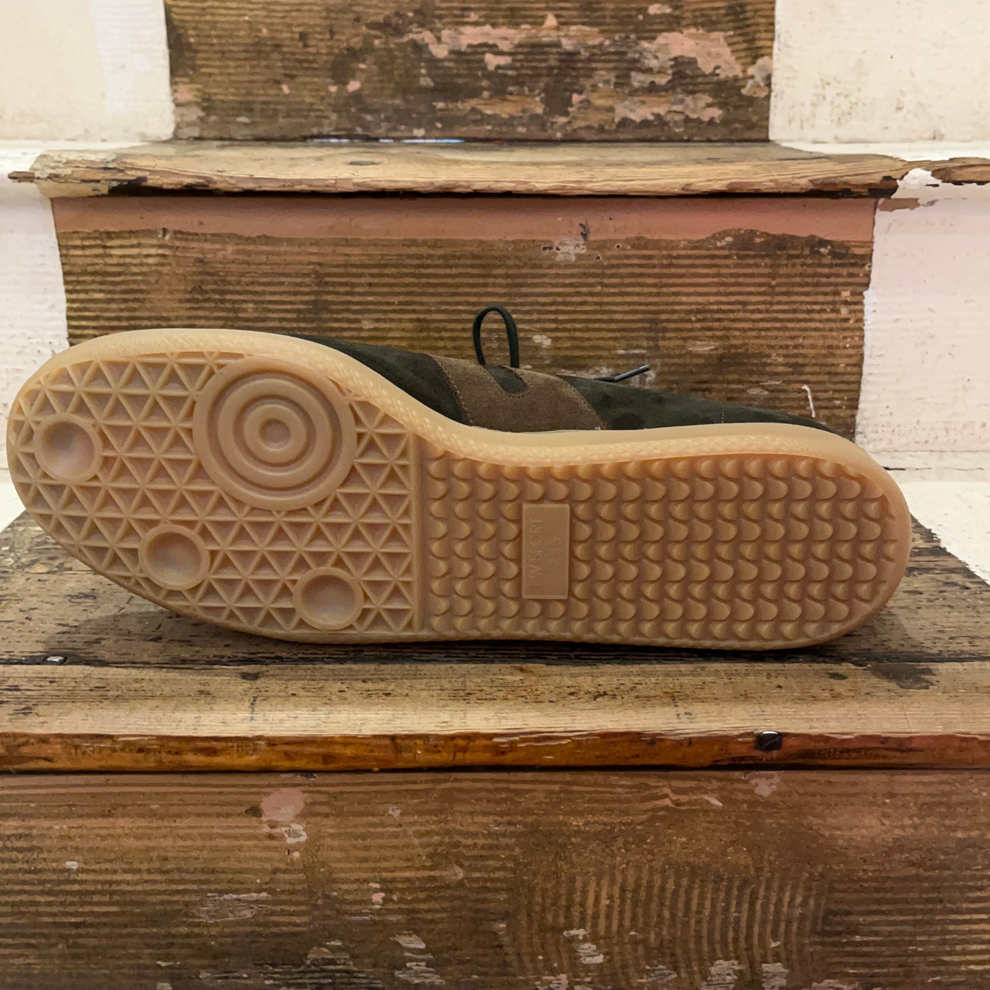 Ludwig Reiter green suede trainer on stairs showing gum sole