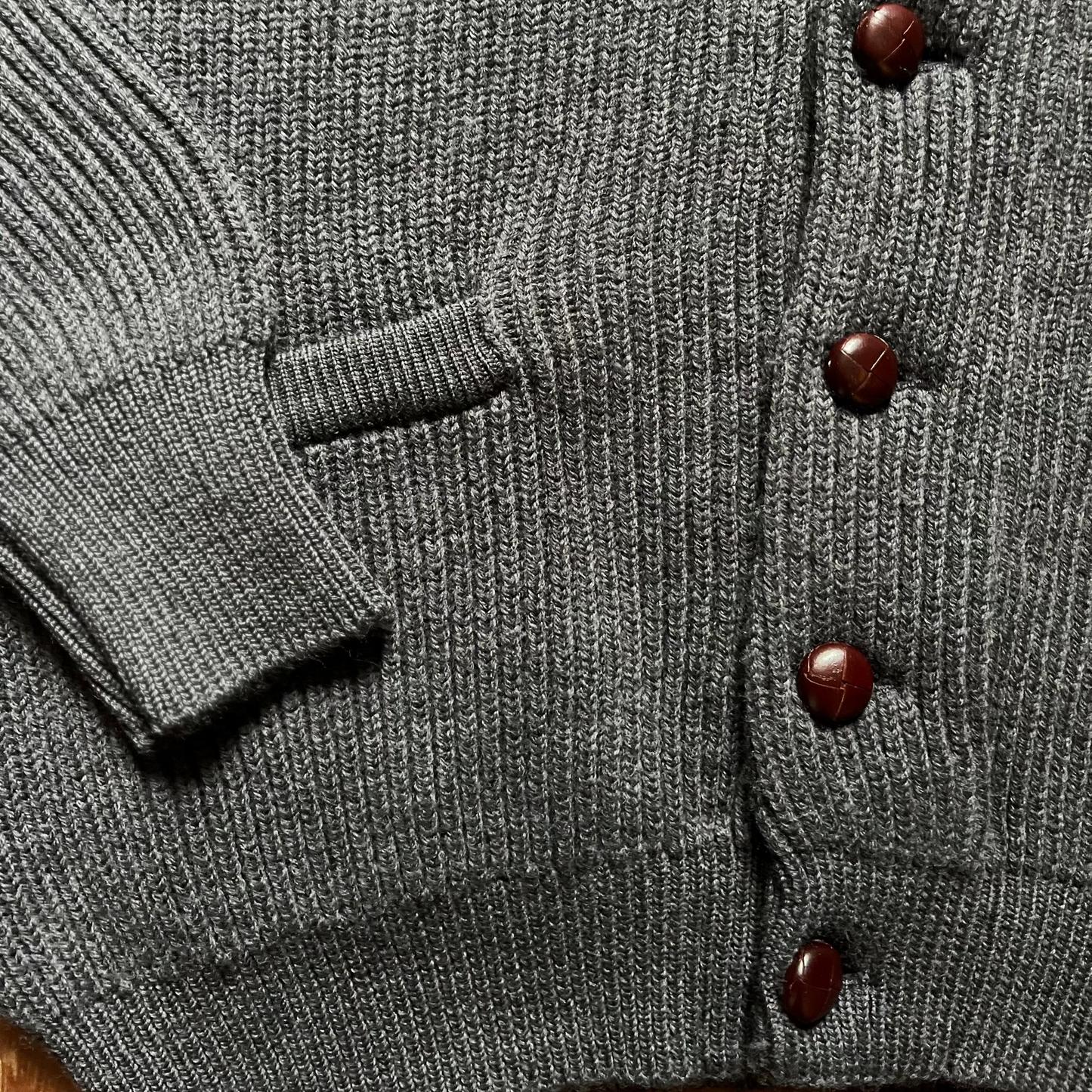 Close up of the leather buttons of REGENT Shawl Collar Merino Wool Ribbed Cardigan in Charcoal Grey