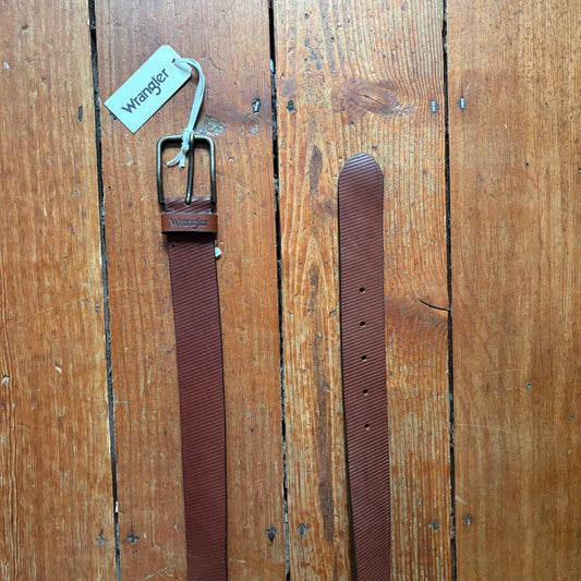 Brown belt with a tag on a wooden surface