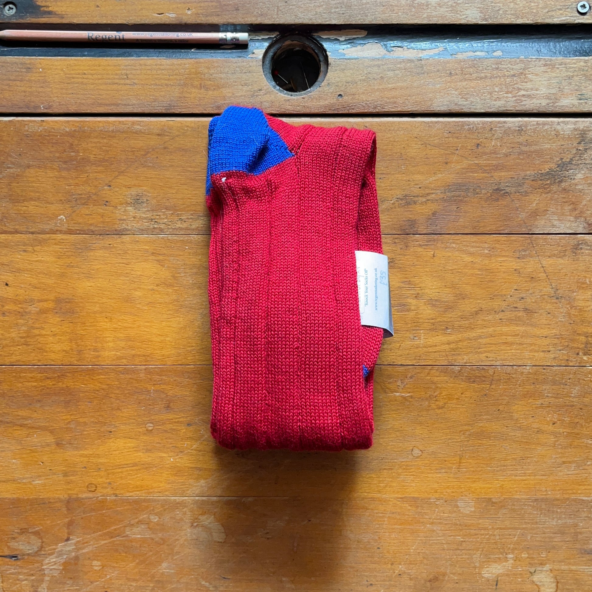 reverse of crimson red boot sock showing royal blue heel