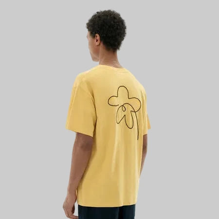 Person wearing a yellow t-shirt with a graphic design on a white background