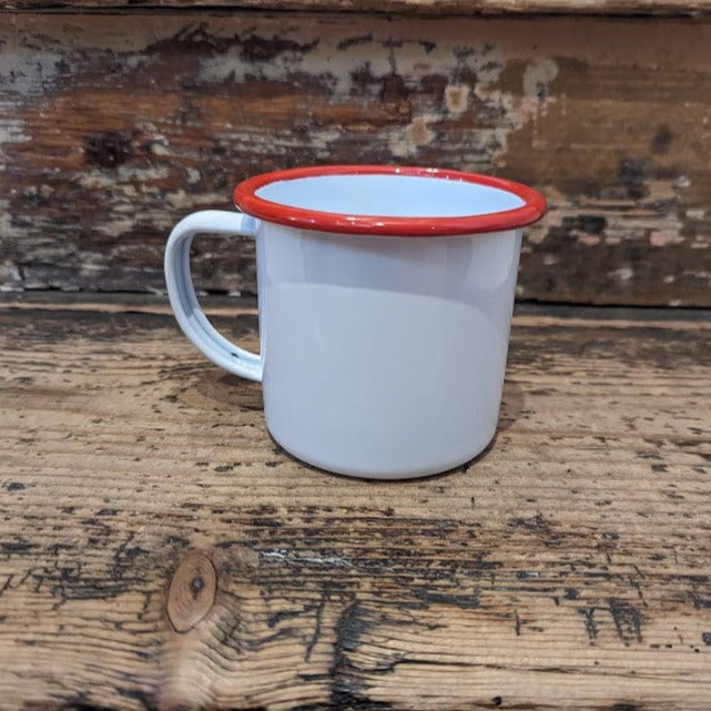 White enamel mug curved handle and red trim.