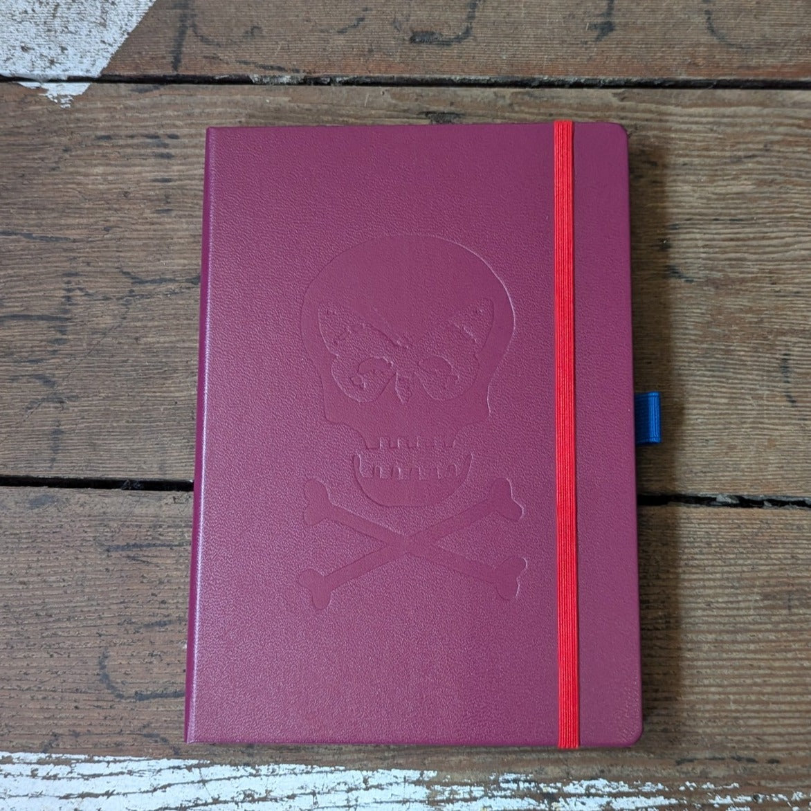 Port Red Notebook, Regent skull embossed on front.