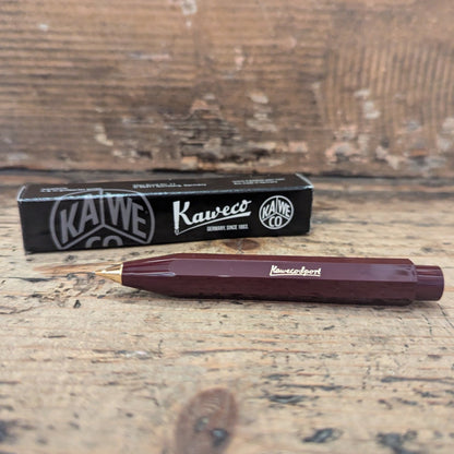 Burgundy Kaweco Ballpoint pen with box packaging on wooden background