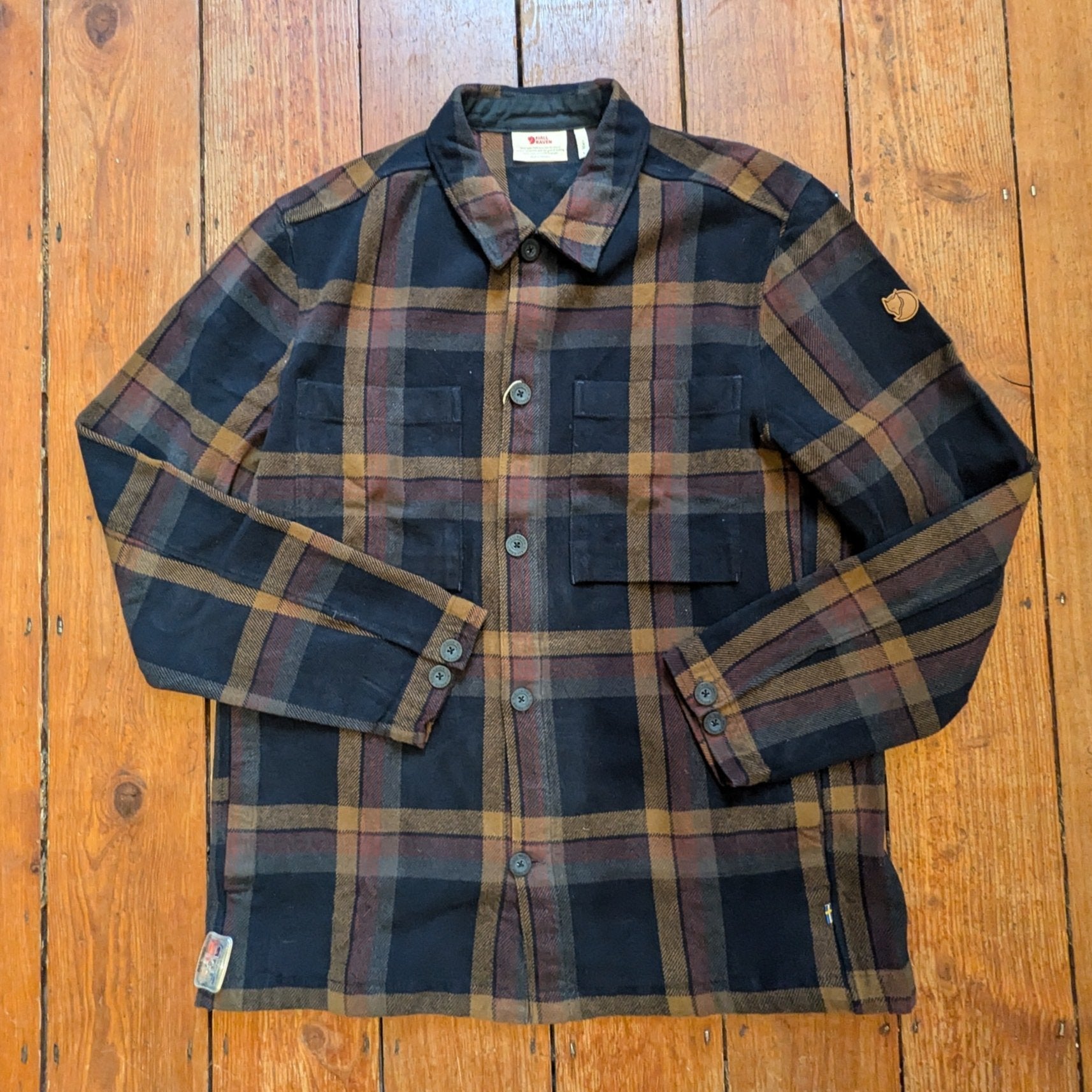 brown check overshirt with large patch pockets, button up cuffs and seam pockets for the hands 