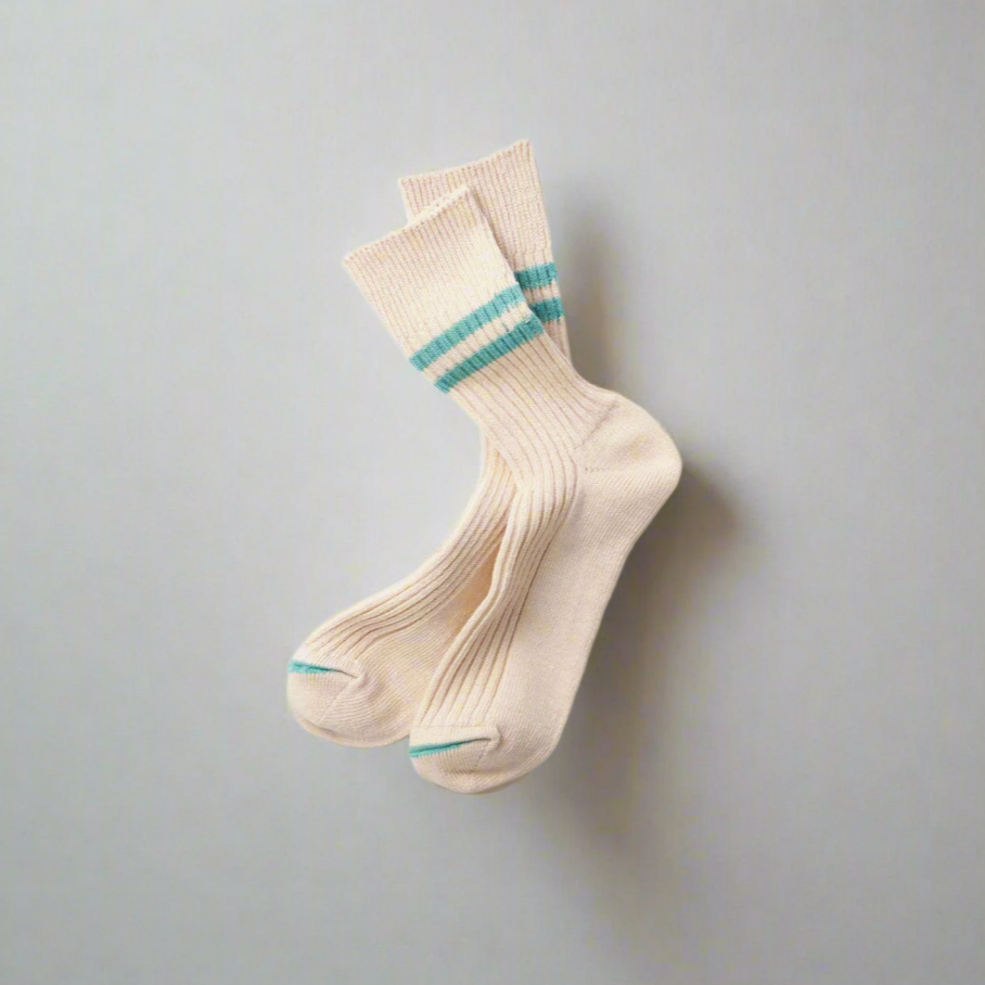 A pair of white socks with turquoise stripes