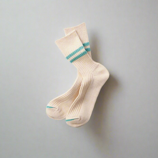 A pair of white socks with turquoise stripes